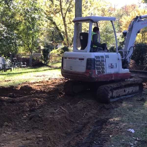 Backhoe Filling In Geothermal Vertical Closed-Loop Geothermal Pipe Field Trenches